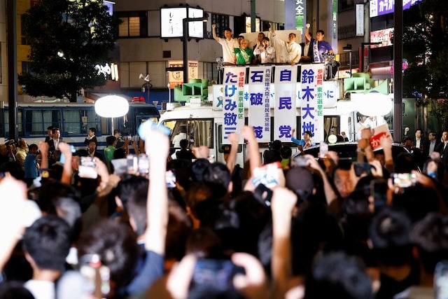 Japan's Prime Minister Shigeru Ishiba, leader of the Liberal Democratic Party (LDP), raises his fist from atop the campaigning bus on the last day of campaigning for the July 20 upper house election, in Tokyo, Japan Jul 19, 2025.