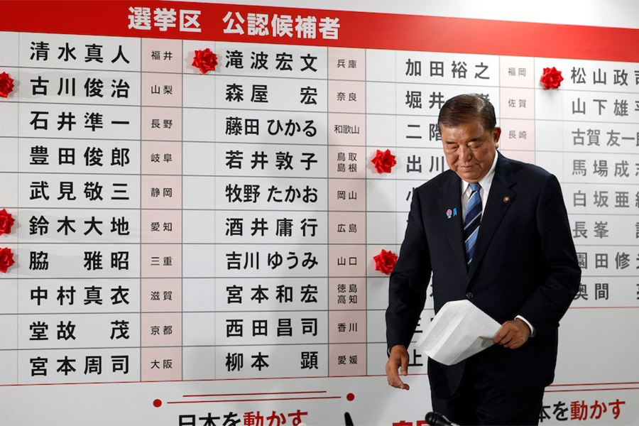 Shigeru Ishiba, Japan's Prime Minister and president of the ruling Liberal Democratic Party (LDP), walks in front of a board with red paper roses showing elected candidates at the LDP headquarters, on the day of Upper House election, in Tokyo, Japan on July 20, 2025 — Pool via REUTERS