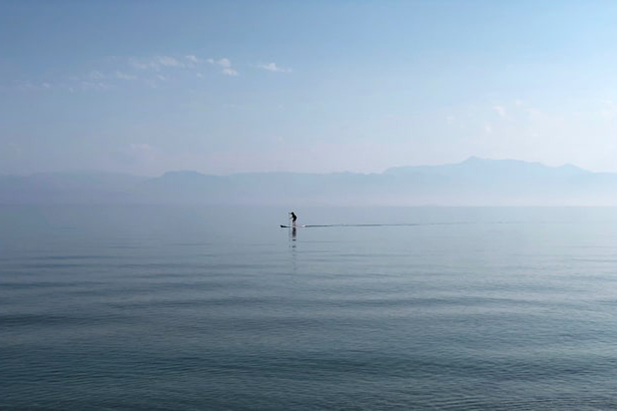 A man paddles in the waters of the Ionian Sea near Sidari settlement on the island of Corfu, Greece July 26, 2019.