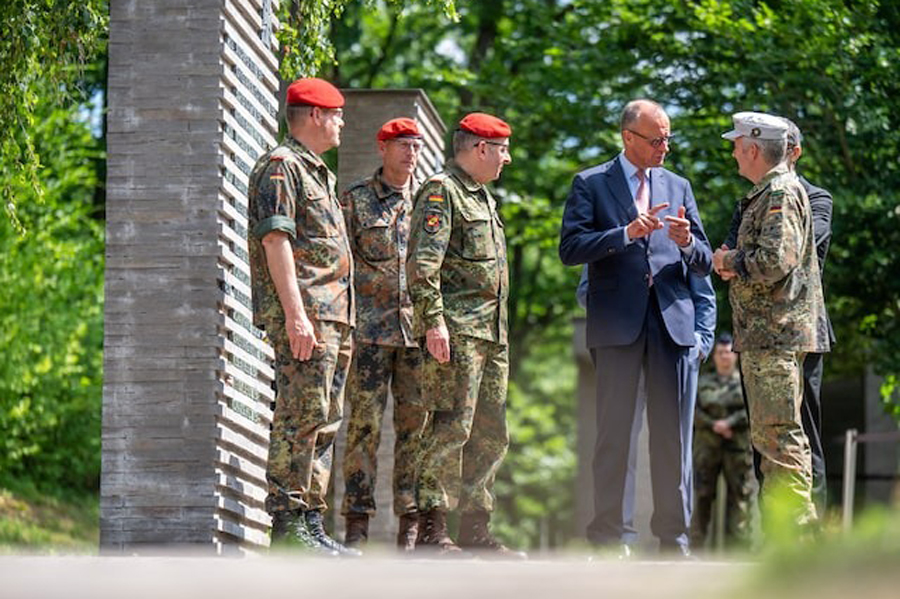 German Chancellor Friedrich Merz talks to soldiers in the so-called "Forest of Remembrance" following his visit to the Operational Command of the German armed forces Bundeswehr in Schwielowsee near Berlin, Germany, June 28, 2025.
