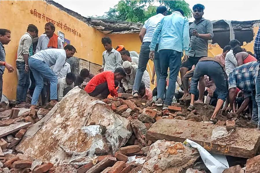 Locals during the rescue work after a government school building collapsed, in Jhalawar district, Rajasthan, Friday, July 25, 2025. At least four students were killed and 17 others suffered injuries in the incident.