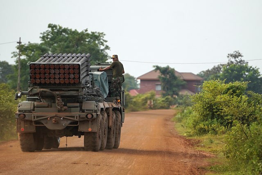 A Cambodian military personnel stands on a BM-21 Grad multiple rocket launcher, around 40 km (24 miles) from the disputed Ta Moan Thom temple, after Thailand and Cambodia exchanged heavy artillery on Friday as their worst fighting in more than a decade stretched for a second day, in Oddar Meanchey province, Cambodia, July 25, 2025.