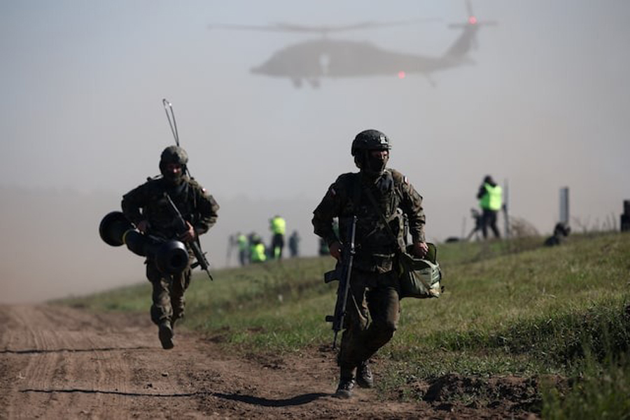 Polish soldiers run during trial drills prior to annual artillery show ‘Autumn Fire 23’ at a military range in Bemowo Piskie near Orzysz, Poland, September 16, 2023.