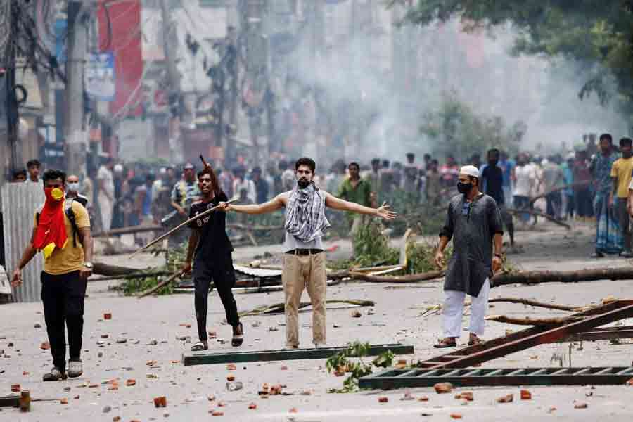 A demonstrator gestures as protesters clash with Border Guard Bangladesh (BGB) and the police outside the state-owned Bangladesh Television as violence erupts across the country after anti-quota protests by students, in Dhaka, Bangladesh, July 19, 2024.