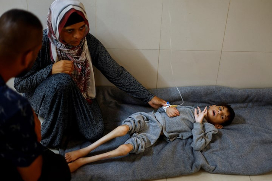Palestinian mother Ghaneyma Joma sits next to her malnourished son Younis Joma as he receives treatment at Nasser hospital in Khan Younis, in the southern Gaza Strip on July 8, 2024 — Reuters/File