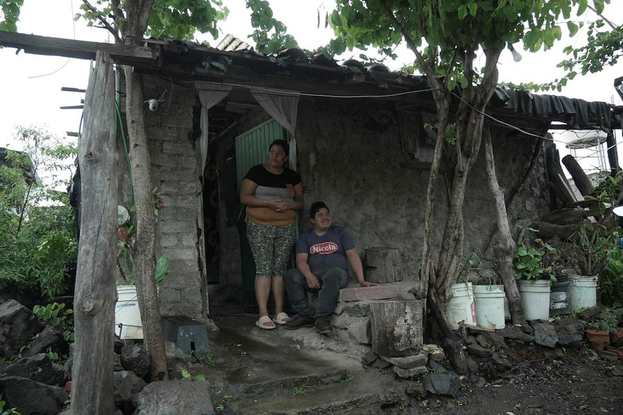 Sonia Coria and her husband Carlos Leon, Mexican migrants who fled cartel violence in their hometown with their family and sought refuge in Arizona, US, before voluntarily returning to Mexico, look on outside their home in Uruapan, Michoacan state, Mexico, July 23, 2025.