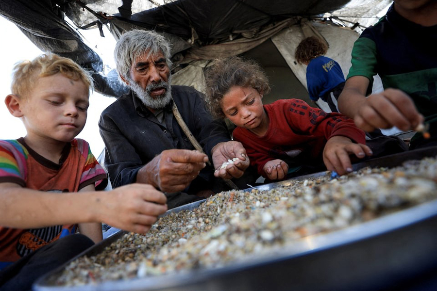 Displaced Palestinians who have not received humanitarian aid gather as they survive on leftover food, amid a hunger crisis, in Gaza, July 28, 2025.