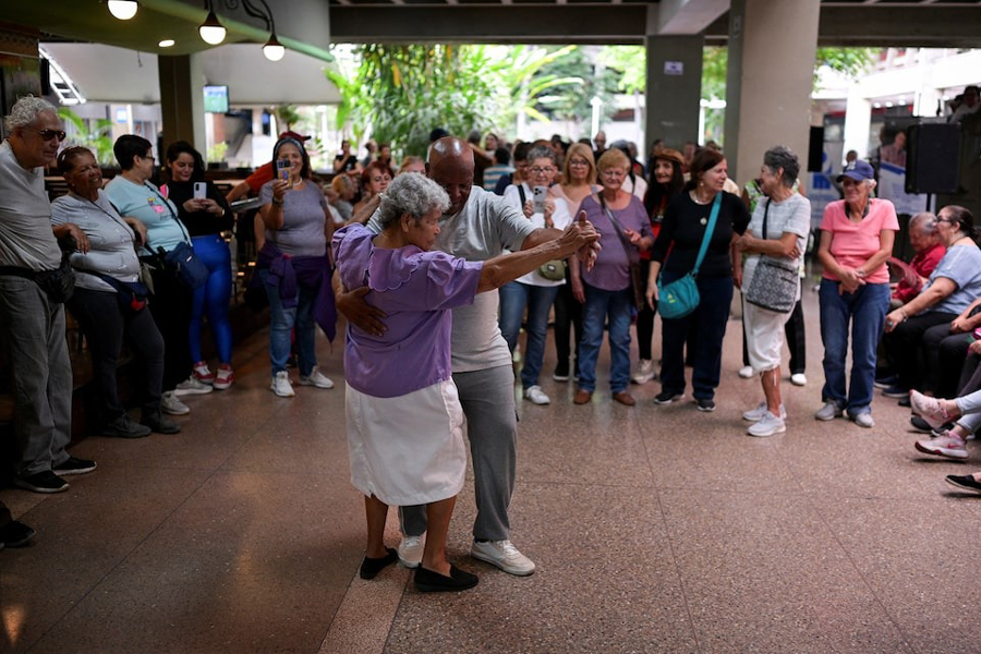 People sing and dance during the weekly gathering of Club Tobias at a shopping mall, in Caracas, Venezuela July 9, 2025.
