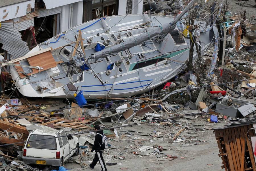 A man walks near a stranded yacht in the tsunami-hit area in Ofunato, Iwate Prefecture, Japan, March 15, 2011, four days after the disaster.