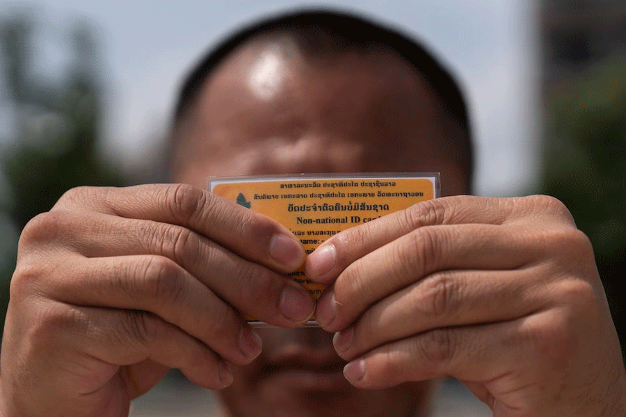 A Lao man deported from the US holds up his non-national ID card - a document that defines his legal status in the country he left behind decades ago, and to which he has now returned, in Vientiane, Laos, July 31, 2025.