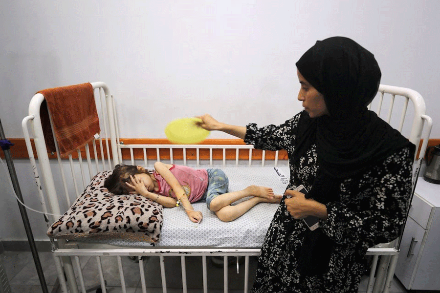 Nasma Ayad fans her daughter, Jana Ayad, who is malnourished, according to medics, as she receives treatment at a hospital in Gaza City, amid a worsening hunger crisis, July 29, 2025.