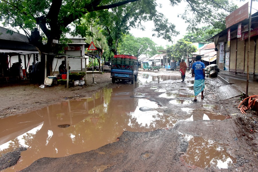 Photo shows potholes have developed on the Uthuli-Jafarganj road in Shibaloy upazila of Manikganj district