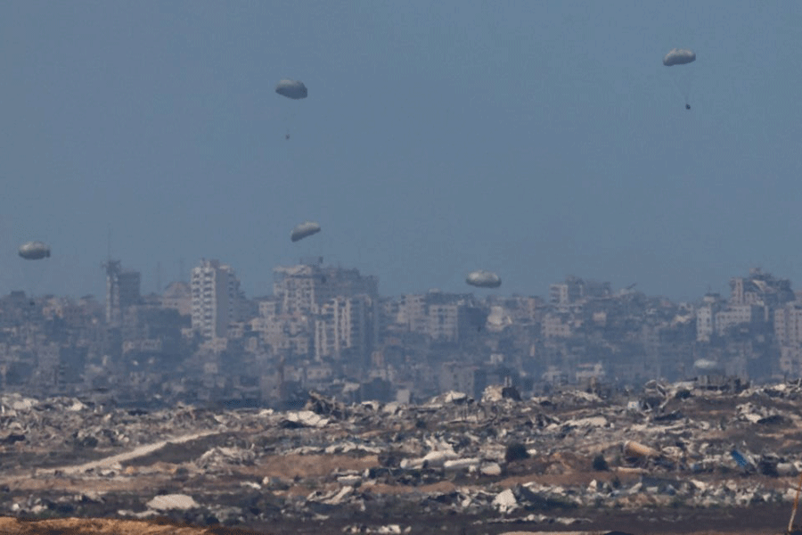 Humanitarian aid packages are airdropped over the Gaza Strip, as seen from Israel, August 3, 2025.