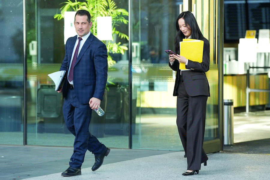 The woman's lawyers, pictured here leaving court, unsuccessfully applied for her to be granted bail. (ABC News: Adam Kennedy)