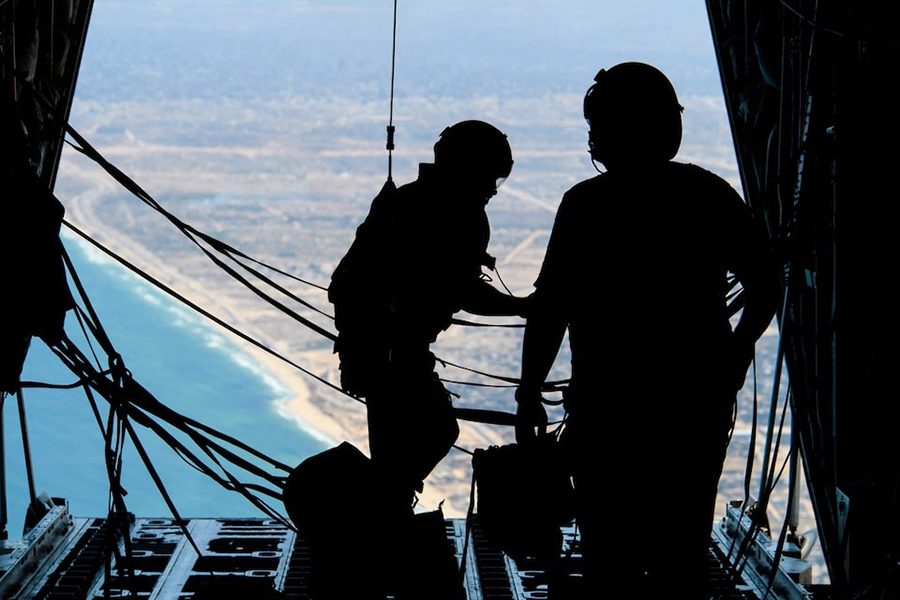 Crew members of a Royal Canadian Air Force CC-130 Hercules transport aircraft stand on the ramp during a mission to airdrop some of approximately 21,600 lbs of humanitarian aid over the Gaza Strip on August 4, 2025 — Canadian Forces/Handout via REUTERS