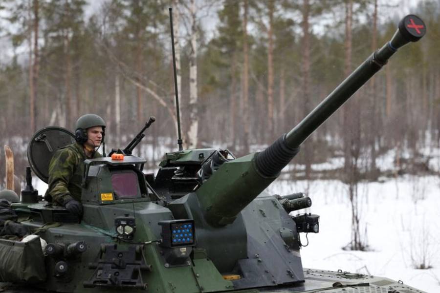 A member of the Swedish Army sits in a tank as Swedish Army armoured vehicles and tanks participate in a military exercise called "Cold Response 2022", gathering around 30,000 troops from NATO member countries as well as Finland and Sweden, amid Russia's invasion of Ukraine, in Setermoen in the Arctic Circle, Norway, March 25, 2022.