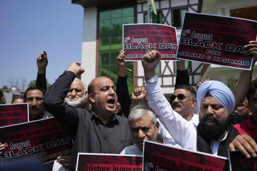 Supporters of India's opposition Congress party hold placards as they demand the ruling government restore the statehood of the disputed region, in Srinagar, Indian-controlled Kashmir, Tuesday, Aug 5, 2025.