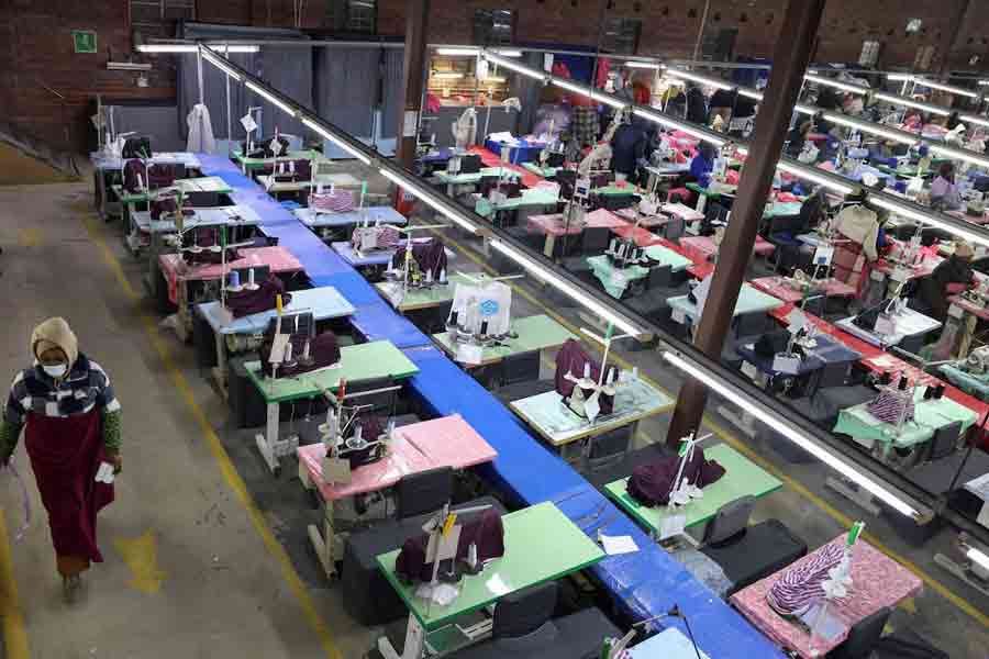 A worker walks past empty sewing stations that were used by employees who have since been laid off, at a garment factory in Maseru, the capital of Lesotho, August 4, 2025.