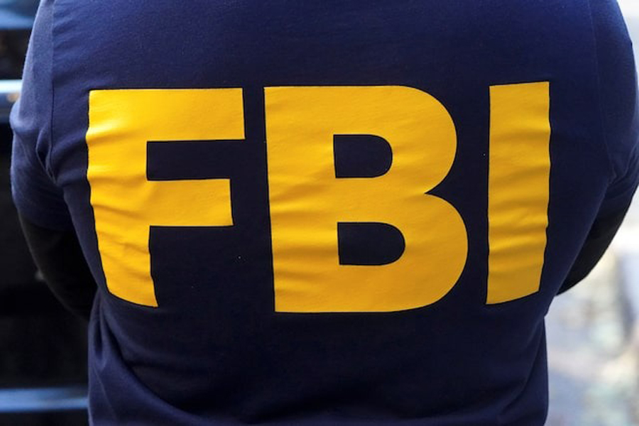 An FBI logo is pictured on an agent's shirt during a raid on a property in the Manhattan borough of New York City, New York, US, October 19, 2021.