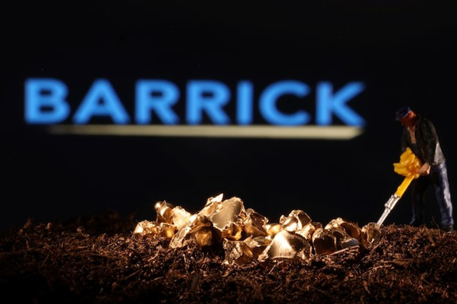 A small toy figure and gold imitation are seen in front of the Barrick logo in this illustration taken November 19, 2021.