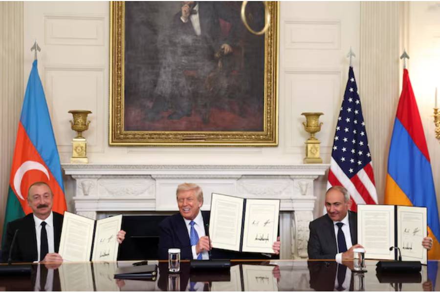 U.S. President Donald Trump, Azerbaijan's President Ilham Aliyev, and Armenia's Prime Minister Nikol Pashinyan pose with their documents during a trilateral signing event at the White House, in Washington, D.C., August 8, 2025.
