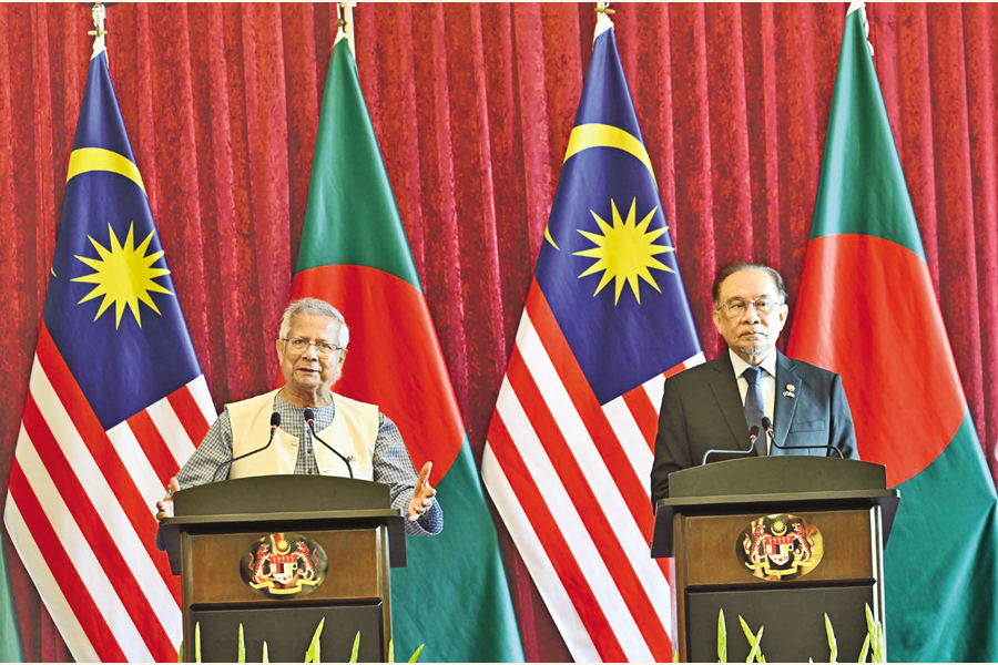 Chief Adviser Prof Muhammad Yunus and Malaysian Prime Minister Anwar Ibrahim speak at a joint press meet at the latter's office in Putrajaya on Tuesday. — PID