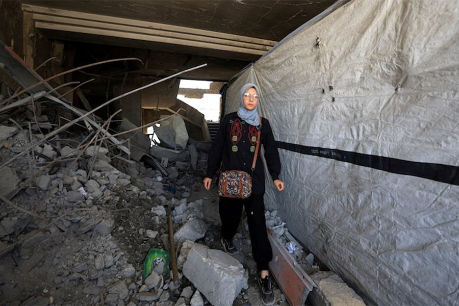 Maha Ali walks inside the damaged Islamic University of Gaza, where she shelters, in Gaza City on June 1, 2025 — Reuters/File