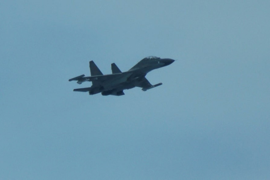 An aerial view of a Chinese fighter jet flying close to a Philippine Coast Guard aircraft carrying journalists during a patrol flight, days after two Chinese vessels collided in the area while allegedly trying to block a Philippine supply mission, over the disputed Scarborough Shoal in the South China Sea, August 13, 2025.
