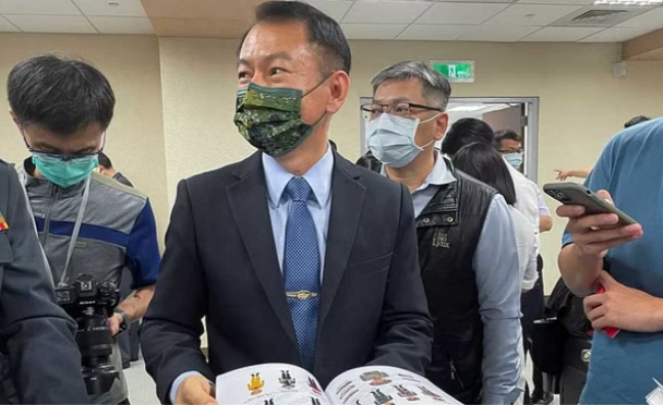 All-Out Defence Mobilisation Agency Director Shen Wei-chih displays the newest version of the Civil Defence Handbook after a press conference in Taipei, Taiwan, Jun 13, 2023. REUTERS