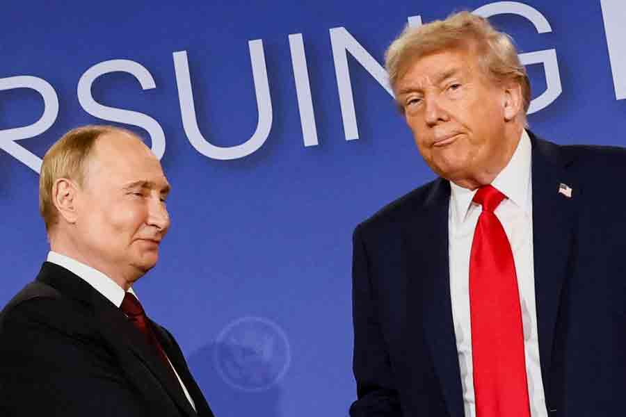 US President Donald Trump looks on next to Russian President Vladimir Putin during a press conference following their meeting to negotiate an end to the war in Ukraine, at Joint Base Elmendorf-Richardson, in Anchorage, Alaska, US, August 15, 2025.