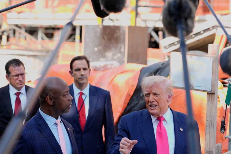 US President Donald Trump, next to US Senator Tim Scott (R-SC), speaks to the media during a tour of the Federal Reserve Board building, which is currently undergoing renovations, in Washington, DC, US, Jul 24, 2025.