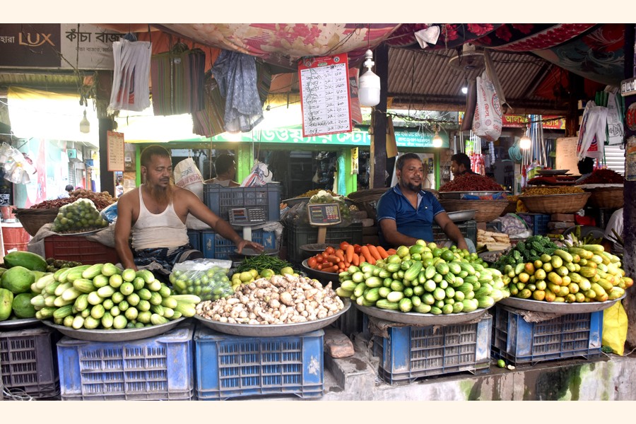 The photo shows vendors sit idle at a vegetable market at Town Bazar in Manikganj on Wednesday as sale has slumped on account of reduced supply due to incessant rainfall- FE Photo