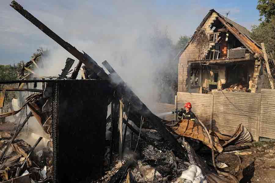 A firefighter works at the site of a Russian missile strike, amid Russia's attack on Ukraine, in the village of Sknyliv on the outskirts of Lviv, Ukraine August 21, 2025.