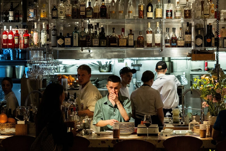 Eployees work in the open kitchen of a restaurant in the Patriarch's Ponds neighbourhood in central Moscow, Russia July 11, 2025.