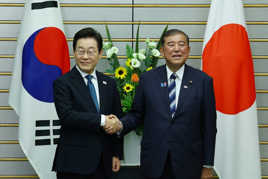 South Korea's President Lee Jae Myung shakes hands with Japan's Prime Minister Shigeru Ishiba in Tokyo, Japan, August 23, 2025.