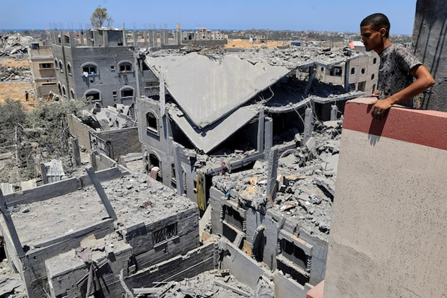 A Palestinian inspects the damage on houses destroyed during an Israeli military operation, in Deir al-Balah, central Gaza Strip, July 23, 2025.