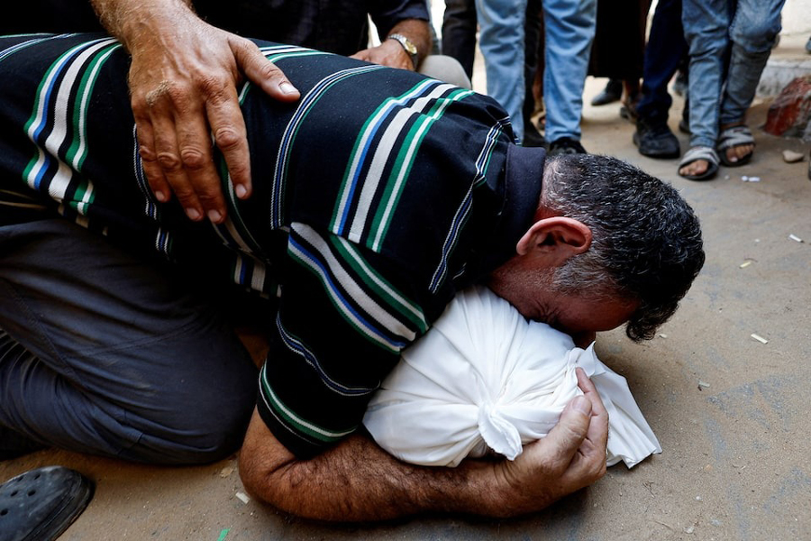 Palestinian father Mahmoud Abedrabo mourns over the body of his son Hamada, who was killed in an Israeli strike, according to medics, at Al-Shifa Hospital in Gaza City, August 24, 2025.