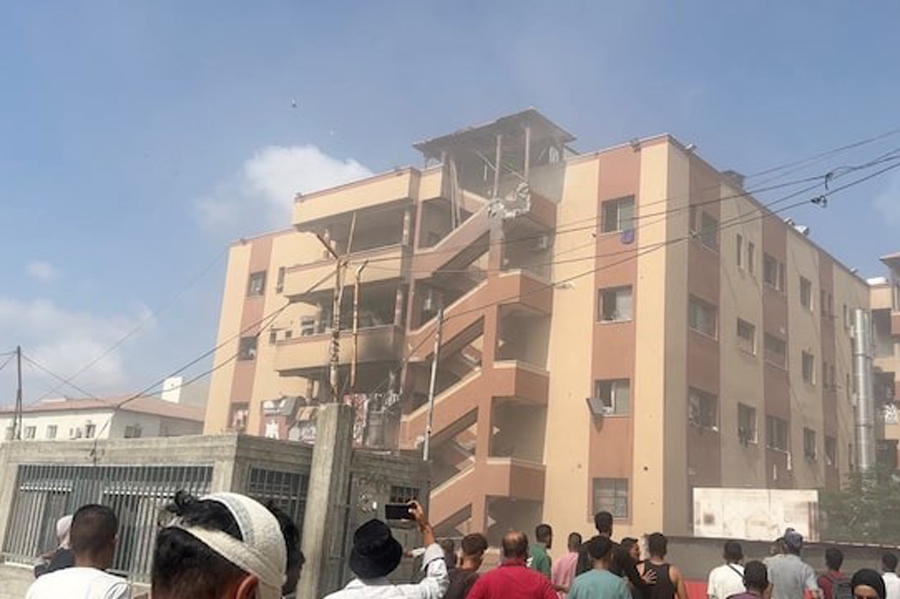 People walk at the site of Israeli strikes on Nasser hospital where Palestinian cameraman Hussam al-Masri, who was a contractor for Reuters, was killed along with other journalists and people, in Khan Younis in the southern Gaza Strip in this still image taken from video, August 25, 2025.