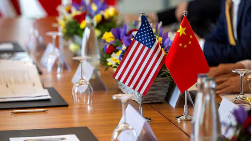 The American and Chinese flags are photographed on the negotiating table, during a bilateral meeting between the United States and China, in Geneva, Switzerland, May 10, 2025. KEYSTONE/EDA/Martial Trezzini/Handout via REUTERS