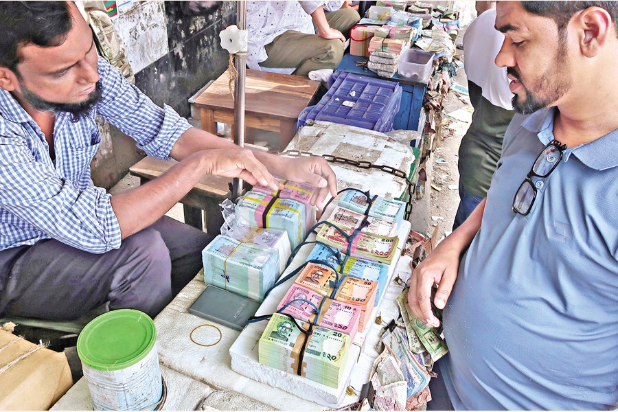 Fresh banknotes are always in demand as they look appealing and attractive. With supply falling short of demand, vendors are charging higher prices. In the photo taken in the Gulistan area on Tuesday, a customer is seen bargaining with a seller to buy fresh notes tied up in bundles on a table