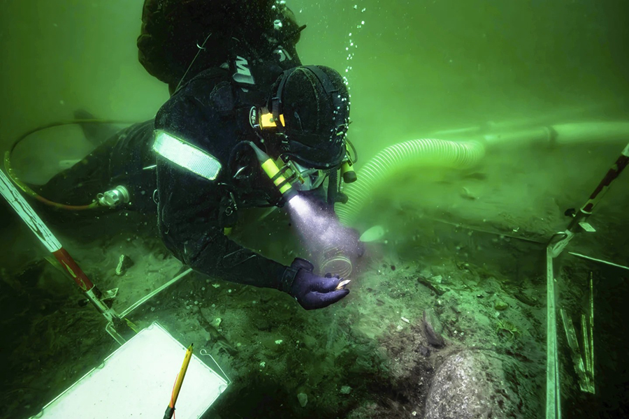 A diver excavates an 8,500-year-old Stone Age coastal settlement, submerged by sea level rise in the Bay of Aarhus, Denmark on August 8, 2025 — AP photo
