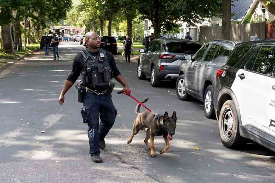 Law enforcement use a K-9 dog to search a nearby neighbourhood, after a shooting at Annunciation Church, which is also home to an elementary school, in Minneapolis, Minnesota, US Aug 27, 2025.