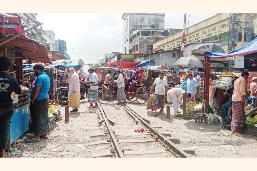 People crossing rail line in a hazardous way risking life at Raza Bazar near Bogura railway station
