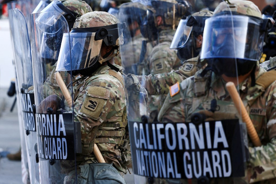 National Guard troops wear gas masks during protests against federal immigration sweeps, in Los Angeles, California, US, June 12, 2025.