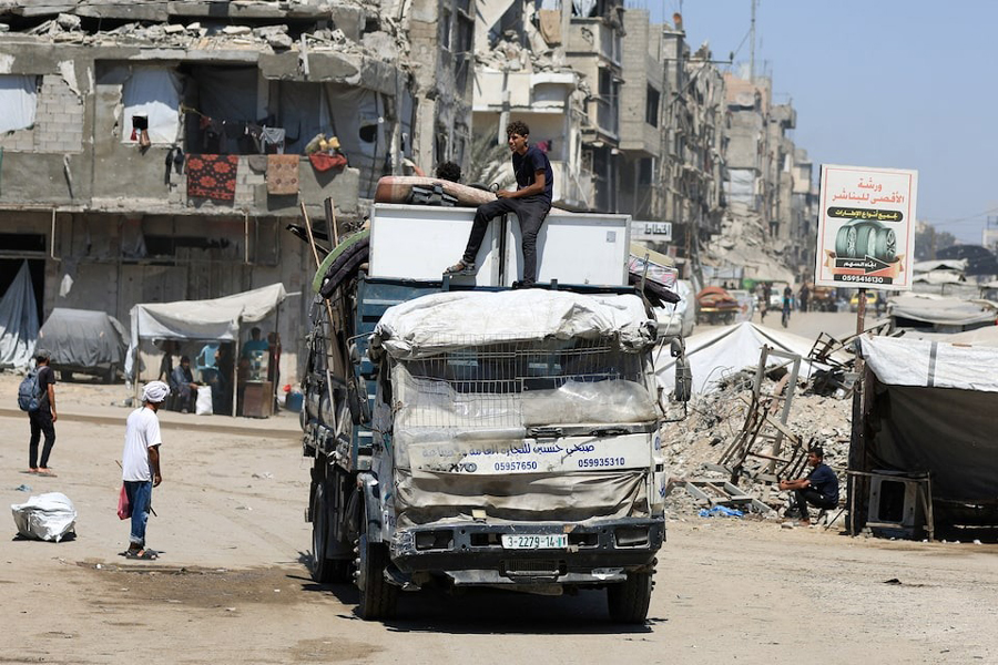 Displaced Palestinians ride on a vehicle loaded with belongings as they flee from one area to another within Gaza City, amid an Israeli military operation, in Gaza City, August 29, 2025.