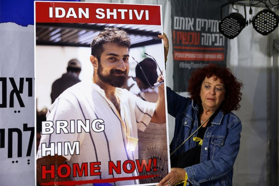 A woman holds a poster with an image of Idan Shtivi, in Tel Aviv, Israel, as hostages are released by the Palestinian militant group Hamas, amid a hostages-prisoners swap deal between Hamas and Israel on November 26, 2023 — Reuters/File