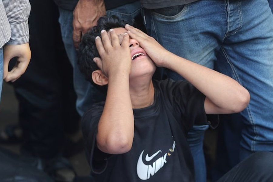 A boy mourns during the funeral of Palestinians killed in overnight Israeli strikes, according to medics, at Al-Shifa Hospital in Gaza City, September 1, 2025.