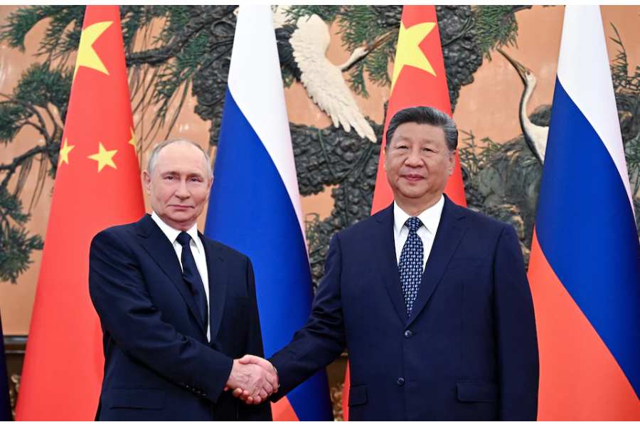 Russian President Vladimir Putin and Chinese President Xi Jinping pose for photos before their meeting in Beijing, China September 2, 2025.