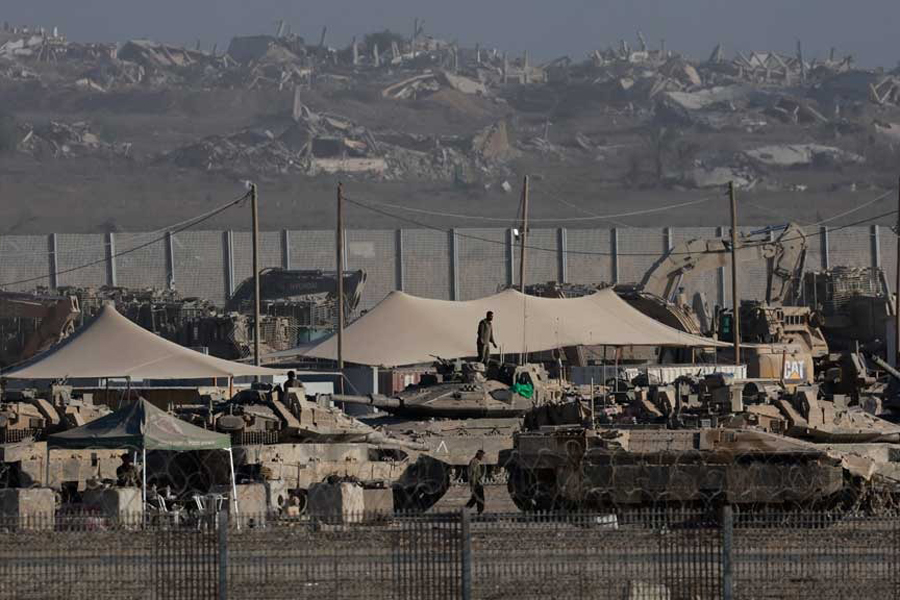 Israel Defense Forces personnel gather near military vehicles and heavy machinery, along the border with Gaza, as seen from the Israeli side, Sept 3, 2025.