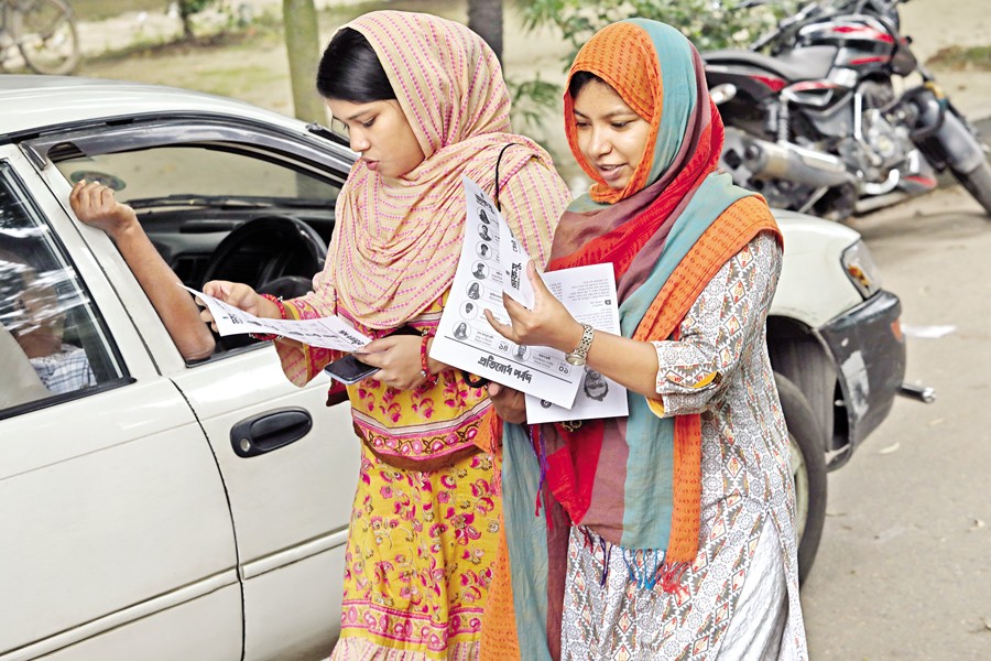 A festive mood now prevails on the campus of Dhaka University as the DUCSU election is just around the corner. Candidates have a hectic schedule trying to persuade students to vote for them. In the photo taken on Wednesday, two enthusiastic students look through election leaflets